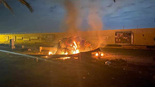This photo released by the Iraqi Prime Minister Press Office shows a burning vehicle at the Baghdad International Airport following an airstrike in Baghdad, Iraq, Friday. The Pentagon said Thursday that the U.S. operation killed Gen. Qassem Soleimani, the head of Iran