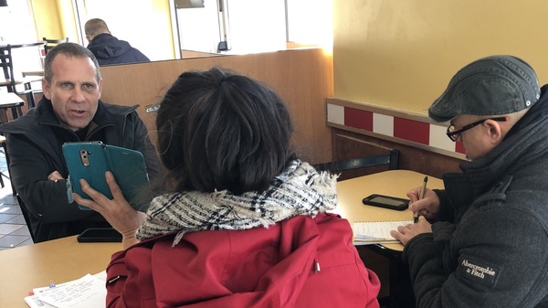 Nick Selby and NYPD officer Luis Sayan interview a retired New York City teacher who lost more than $300,000 to online scammers posing as Chinese police.