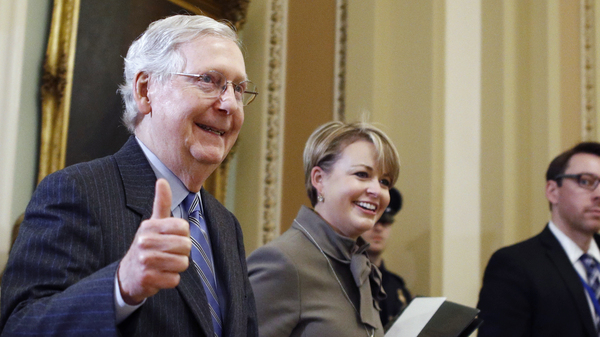 Senate Majority Leader Mitch McConnell, R-Ky., gives a thumbs up as he leaves the Senate chamber during the impeachment trial of President Trump on Friday.