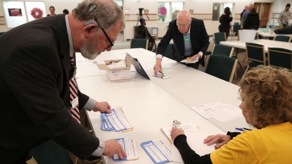 Presidential preference cards are counted at a caucus at West Des Moines Christian Church in Iowa on Monday. Problems with a smartphone app designed to report the caucus results ended up delaying an official count.