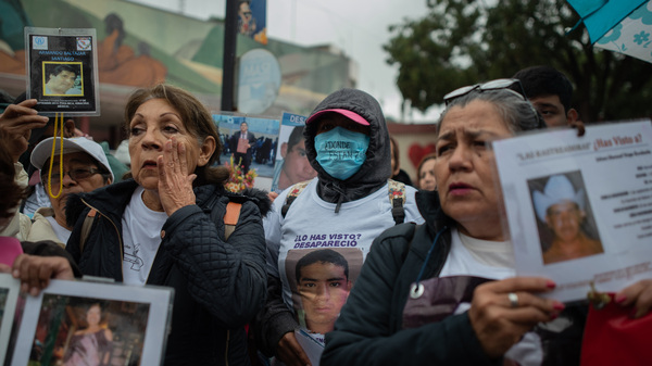 People who gathered in Poza Rico last month brought with them posters, T-shirts and jewelry bearing the images of their missing loved ones.