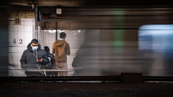 A commuter wearing a medical mask waits for a train Thursday at Grand Central station in New York City. Several dozen cases have been confirmed in the state, and the East Coast as a whole saw its first two confirmed deaths related to COVID-19, in Florida.