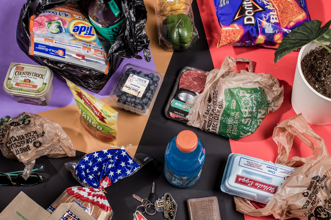 The Plastic Problem Isn't Your Fault, But You Can Be Part Of The Solution : Life Kit 2 Plastic items including drink bottles, plastic bags and food packaging are strewn about atop a bold purple and red backdrop and photographed from above.