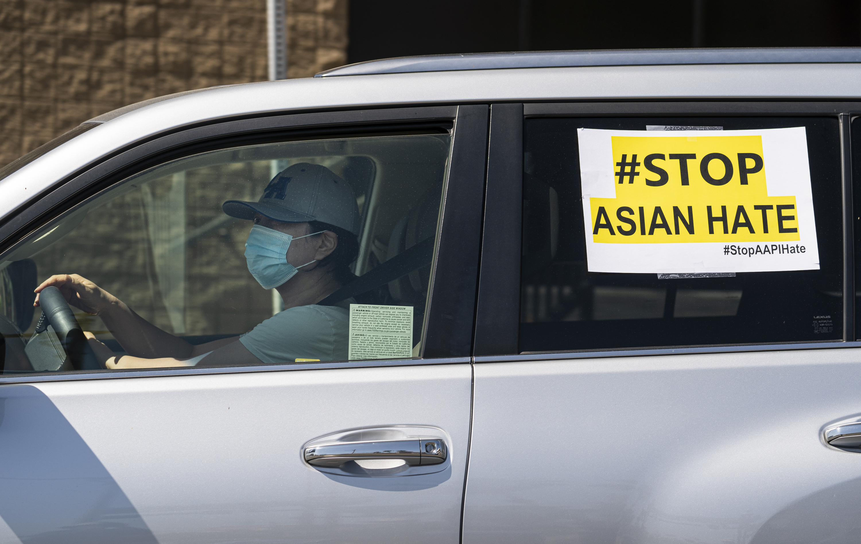 Members of the Korean American Federation of Los Angeles drive with signs reading: "#Stop Asian Hate," in a caravan around Koreatown to denounce hate against the Asian American and Pacific Islander communities in Los Angeles on March 19, 2021.