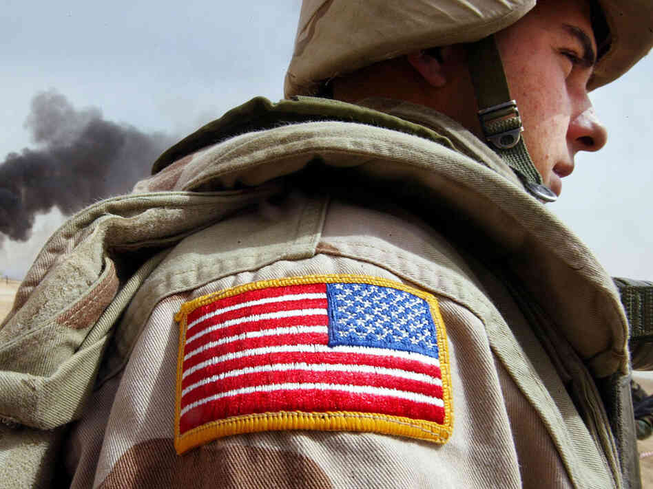 A U.S. soldier stands near an oil well set ablaze by retreating Iraqi troops. A U.S. soldier stands near an oil well set ablaze by retreating Iraqi troops.