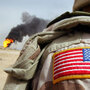 A U.S. soldier stands near an oil well set ablaze by retreating Iraqi troops. A U.S. soldier stands near an oil well set ablaze by retreating Iraqi troops.