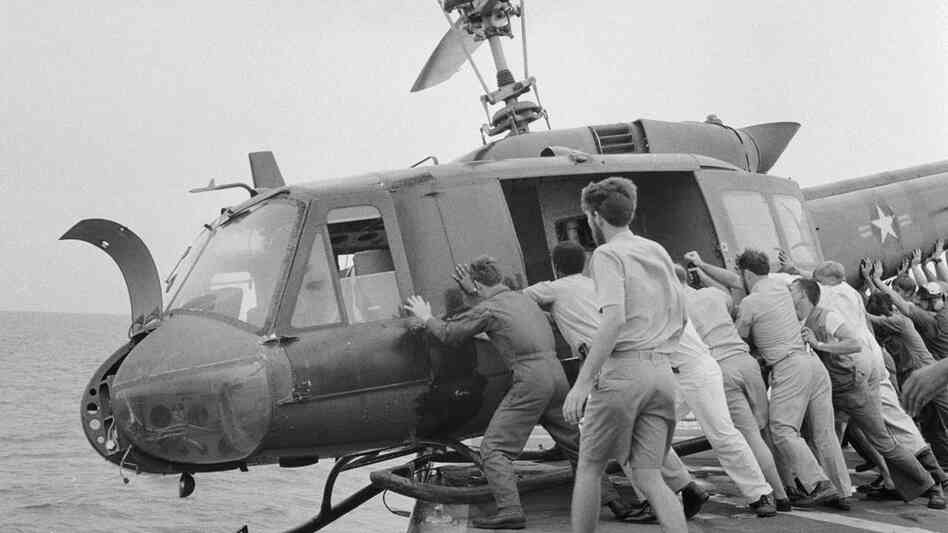 Huey+Helicopter+For+Sale hide caption Crew members push a Huey helicopter into the ocean to ...