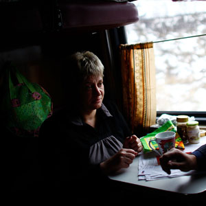 Zhanna Rutskaya (left) and Sergei Yovlev share food on the train, which is traveling to the Russian city of Yaroslavl, about four hours northeast of Moscow. (David Gilkey/NPR)