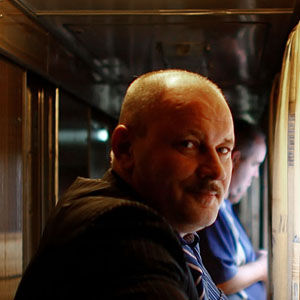 Yovlev, who works for the railroad, stands outside his train compartment during the trip to Yaroslavl, his hometown. (David Gilkey/NPR)