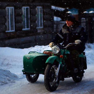 A man rides his motorcycle slowly on the town's ice-covered streets. (David Gilkey/NPR)