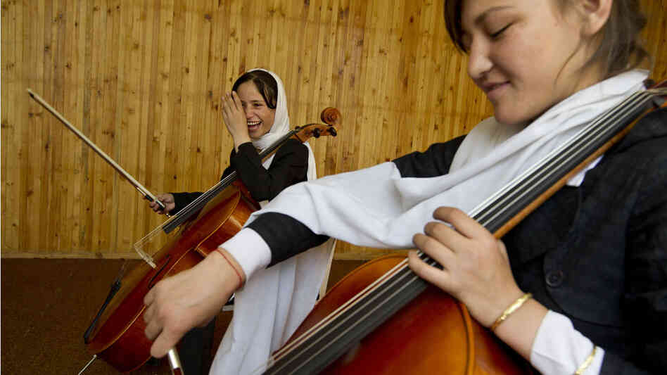 Two 14-year-old Afghan girls practice the cello at the Afghanistan National Institute of Music in Kabul.