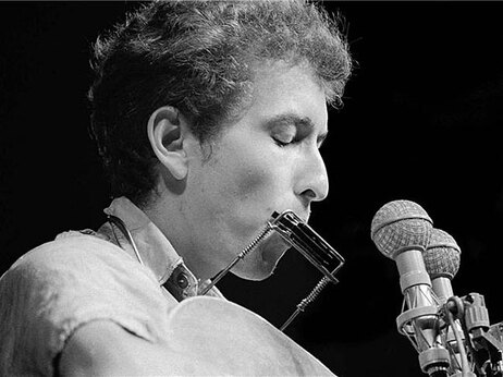 Bob Dylan on stage in, Newport R.I.; credit: Rowland Scherman.