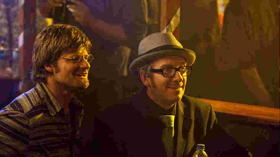 Steve Zahn as Davis McAlary, with Elvis Costello