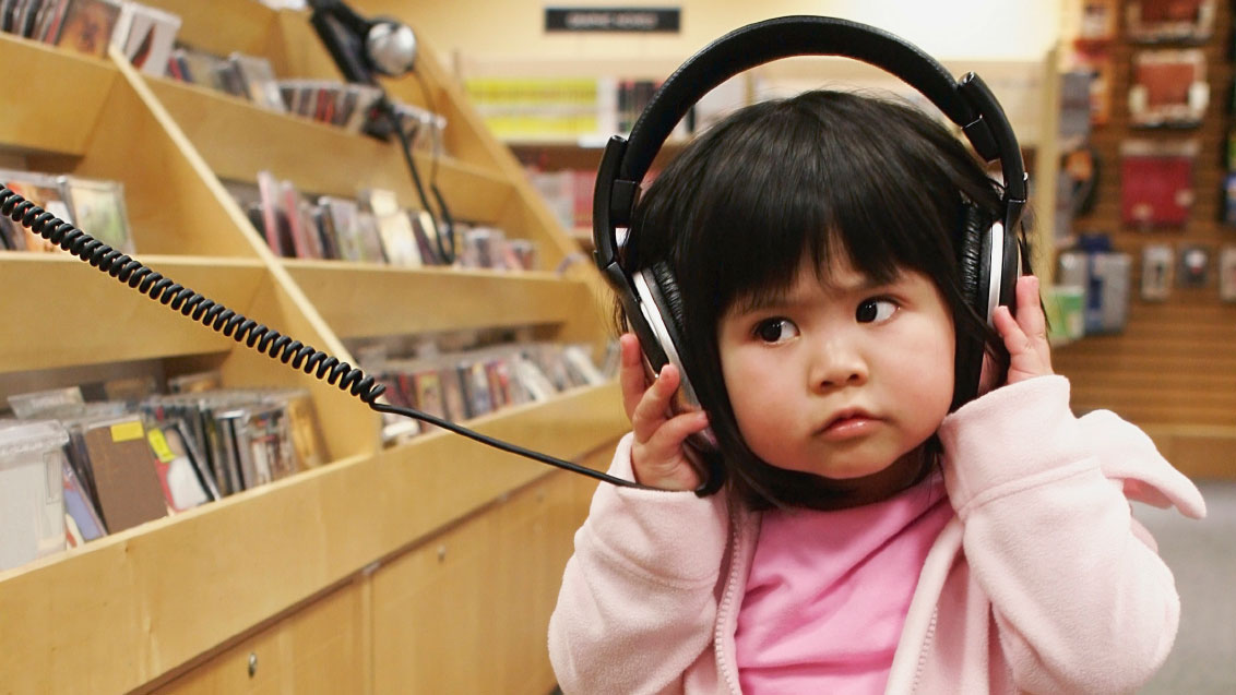 cute kid at a music store.