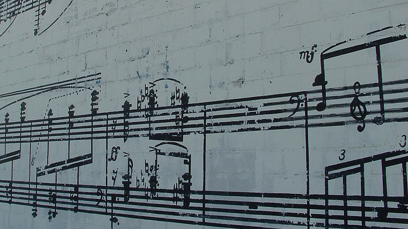 music written on a brick wall