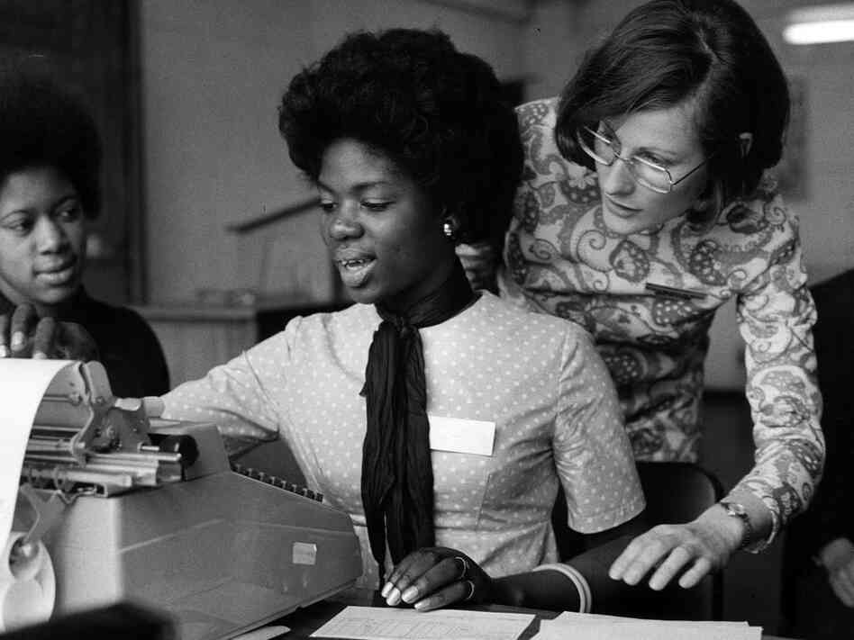 Women around a typewriter; Erich Auerbach/Getty Images