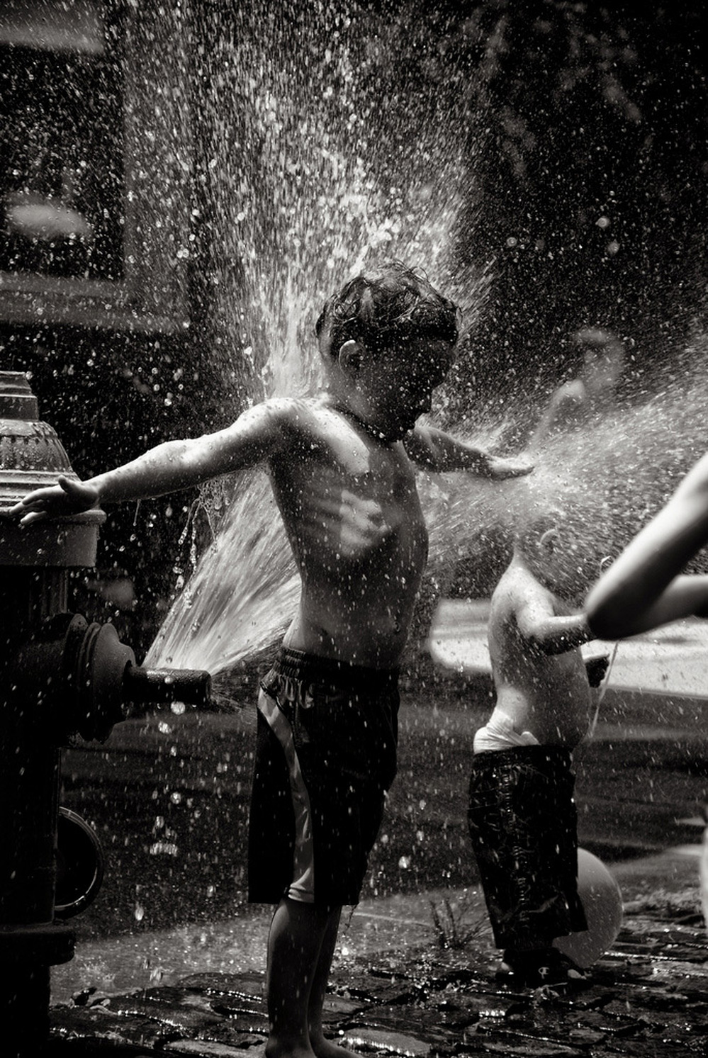 Kid plays in front of a fire hydrant; credit: vcferry via Flickr