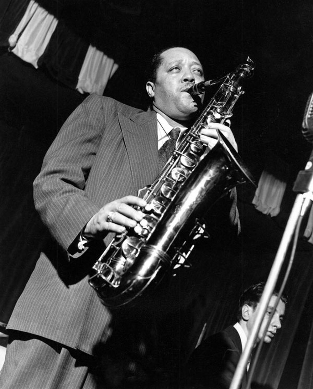 Rather than holding his saxophone vertically, Lester Young held it high and to the right.