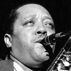 Rather than holding his saxophone vertically, Lester Young held it high and to the right. Rather than holding his saxophone vertically, Lester Young held it high and to the right.