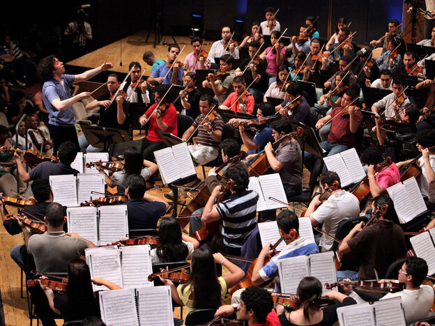 Conductor Gustavo Dudamel leads El Sistema during a June 2009 rehearsal in Caracas, Venezuela.