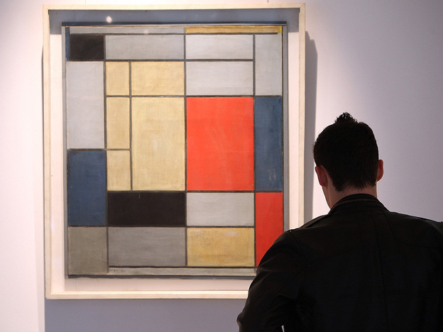 A man looks at 'Composition I' by Piet Mondrian on January 29, 2009, at Christie's in London.