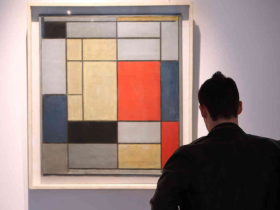 A man looks at 'Composition I' by Piet Mondrian on January 29, 2009, at Christie's in London.