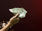 Hand offering money. Hand offering money.