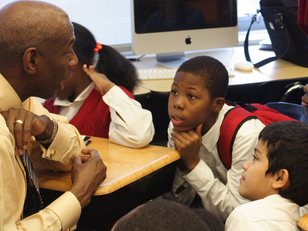 Boys listen to Geoffrey Canada