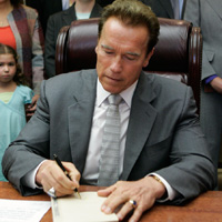 California Gov. Arnold Schwarzenegger signs the state budget on July 28.