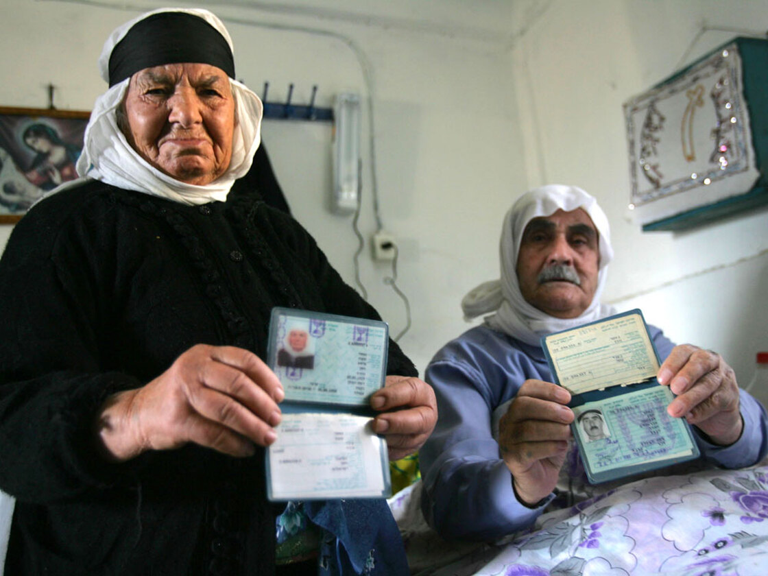 Two Ghajar residents display their Israeli identity documents in 2006.