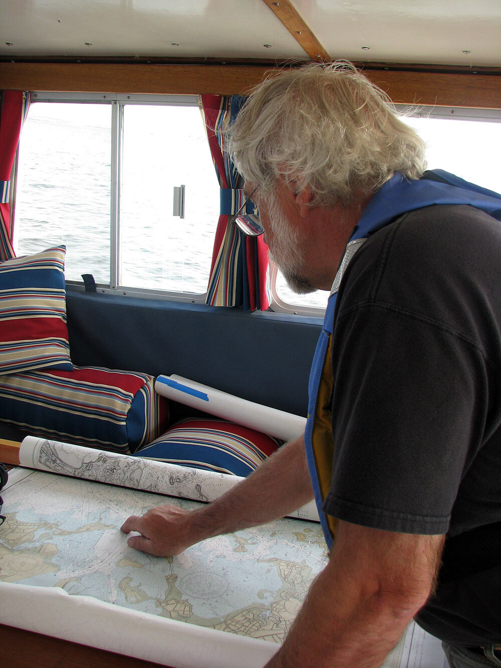 Captain John Williamson examines a chart of Massachusetts Bay.