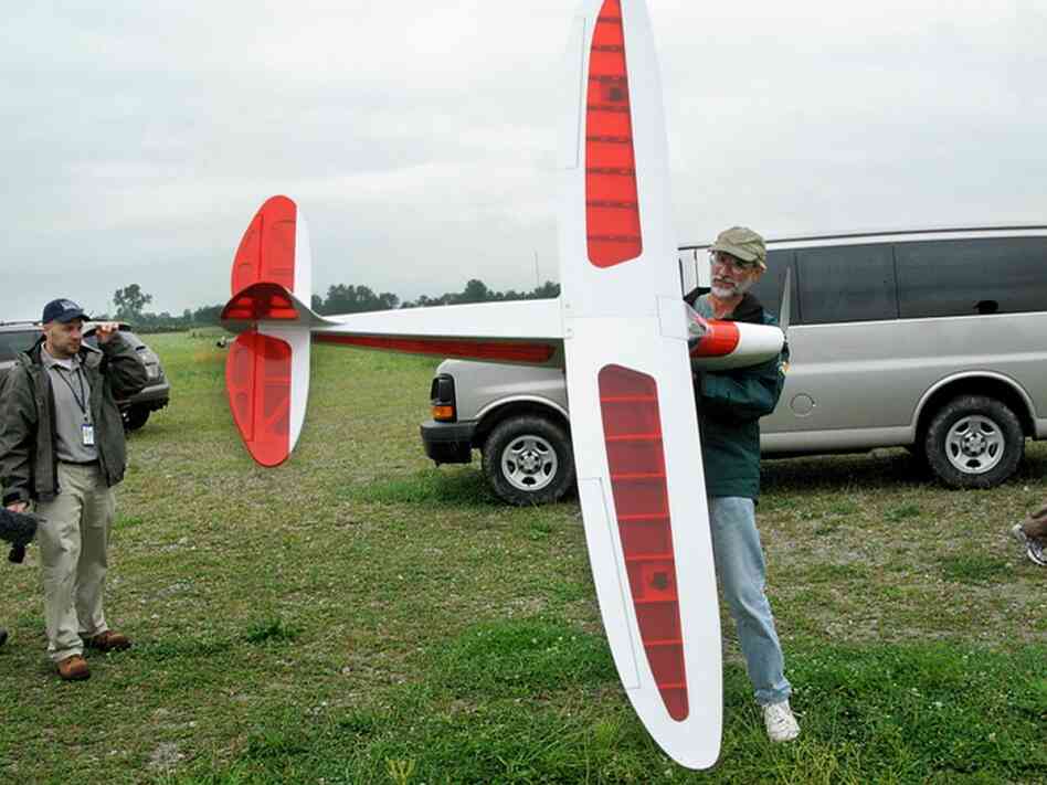 Steven Lima prepares a radio-controlled aircraft for flight. Robert Benincasa/NPR