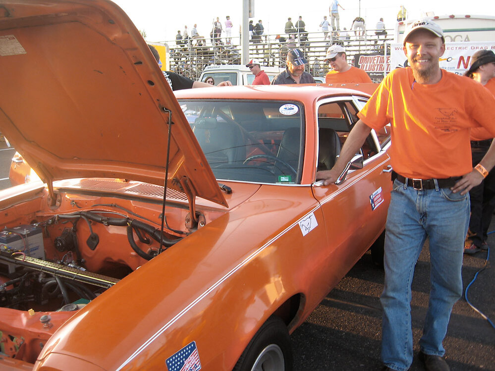 Mike Willmon stands next to his 1978 Ford Pinto at the racetrack.