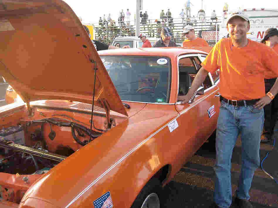 Mike Willmon stands next to his 1978 Ford Pinto at the racetrack.