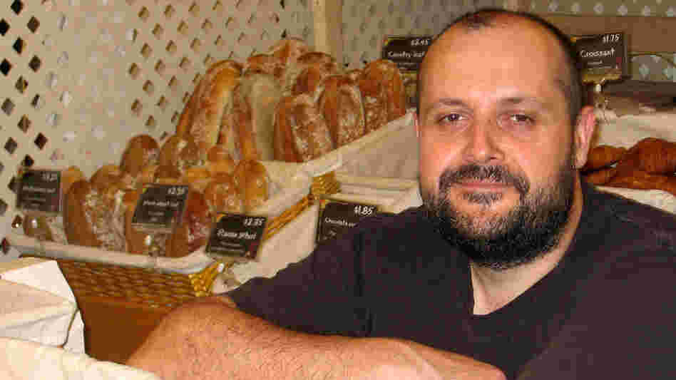 Baker Bertrand Houlier with the sweet treats and breads he makes