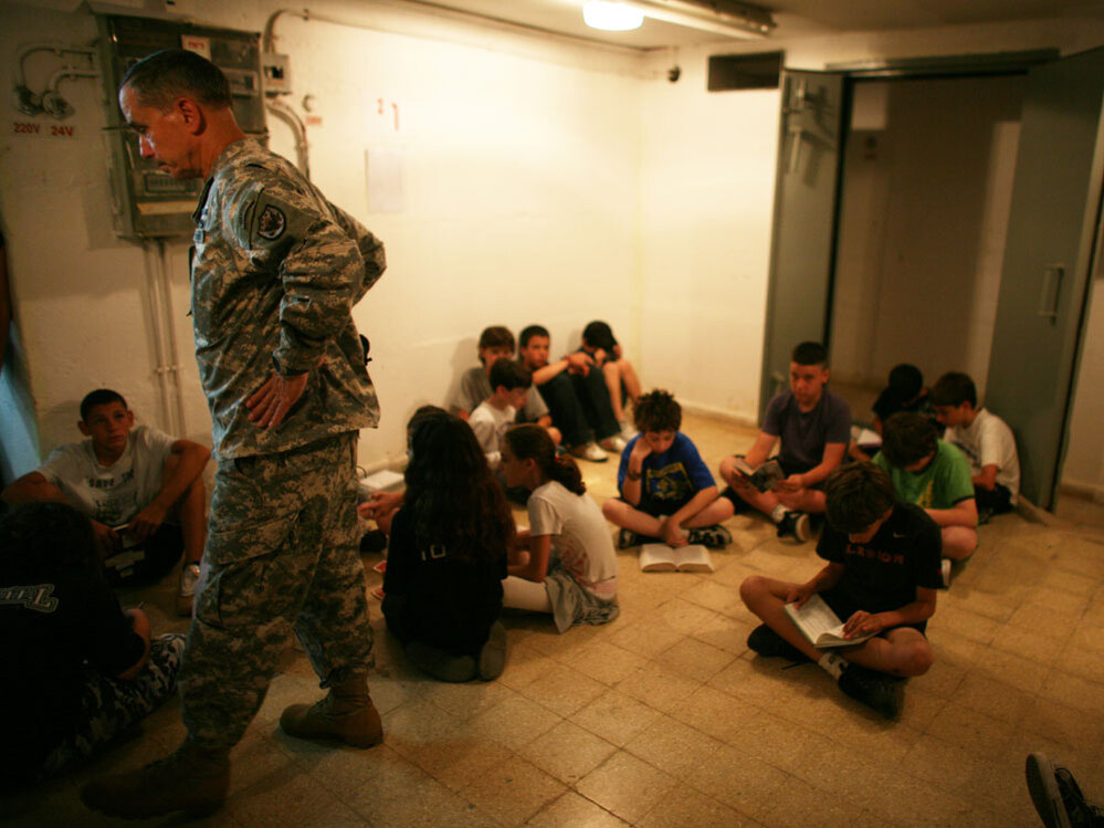 A U.S Army representative joins Israeli schoolchildren in a Tel Aviv bomb shelter, June 2, 2009