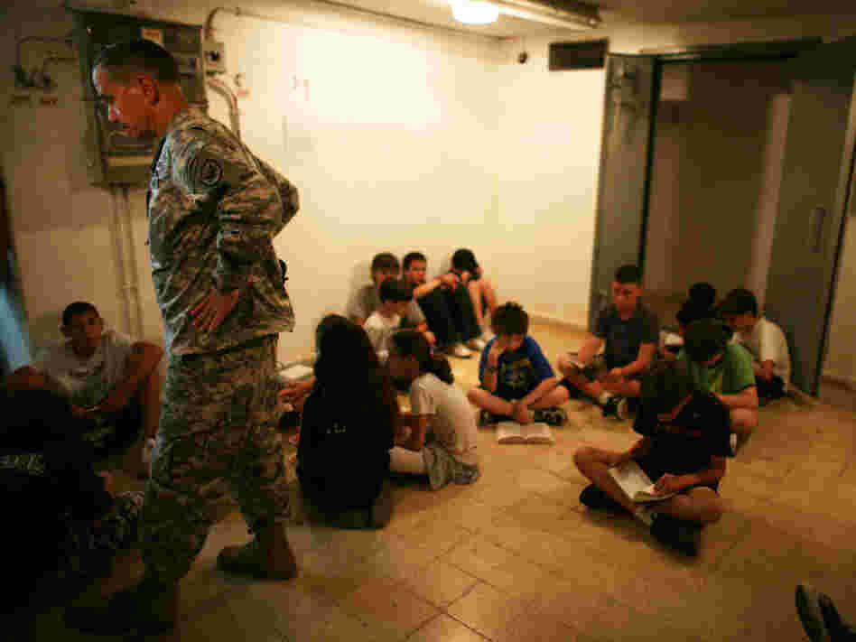 A U.S Army representative joins Israeli schoolchildren in a Tel Aviv bomb shelter, June 2, 2009
