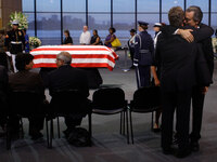 Robert Shriver III (right) embraces his cousin Edward Kennedy Jr. next to the casket of Sen. Edward Kennedy at the John F. Kennedy Presidential Library and Museum in Boston, Thursday.