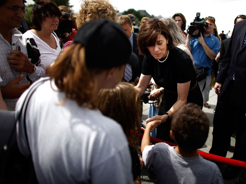 Victoria Kennedy, widow of Sen. Edward Kennedy, greets  people standing in line.
