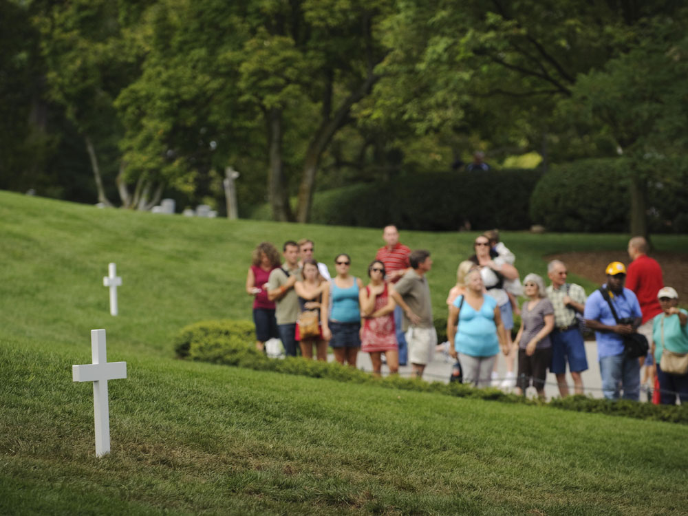 Visitors line up to pay their respects at the gravesite of Sen. Edward Kennedy, a day after his burial in Arlington National Cemetery.