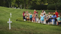 Visitors line up to pay their respects at the gravesite of Sen. Edward Kennedy, a day after his burial in Arlington National Cemetery.