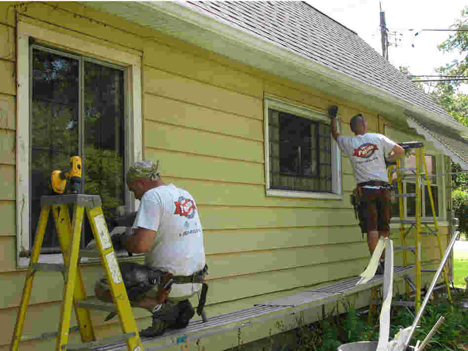 A work crew replaces old windows at a home in Illinois.
