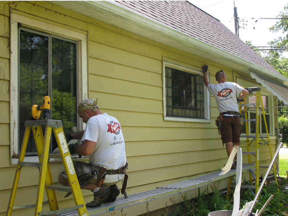 A work crew replaces old windows at a home in Illinois.