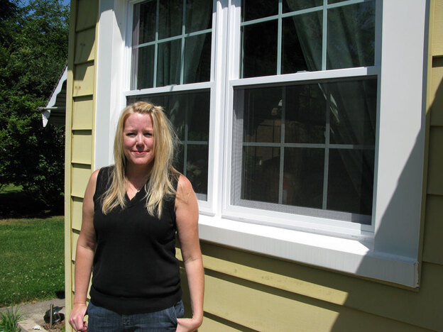 Nancy Munson shows off one of her new replacement windows.