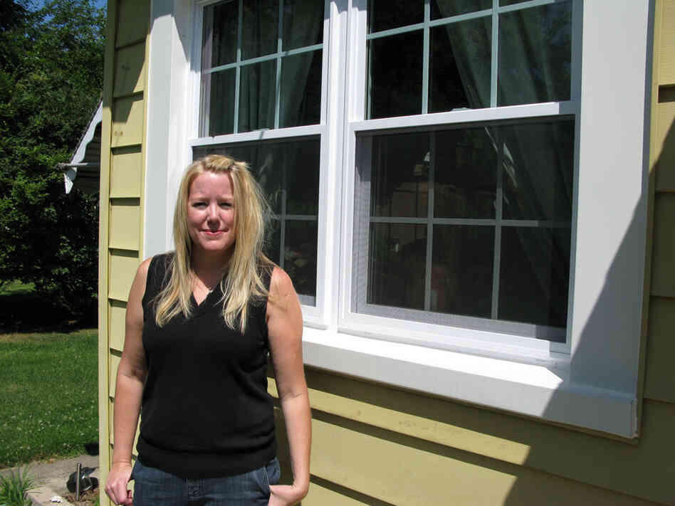 Nancy Munson shows off one of her new replacement windows.