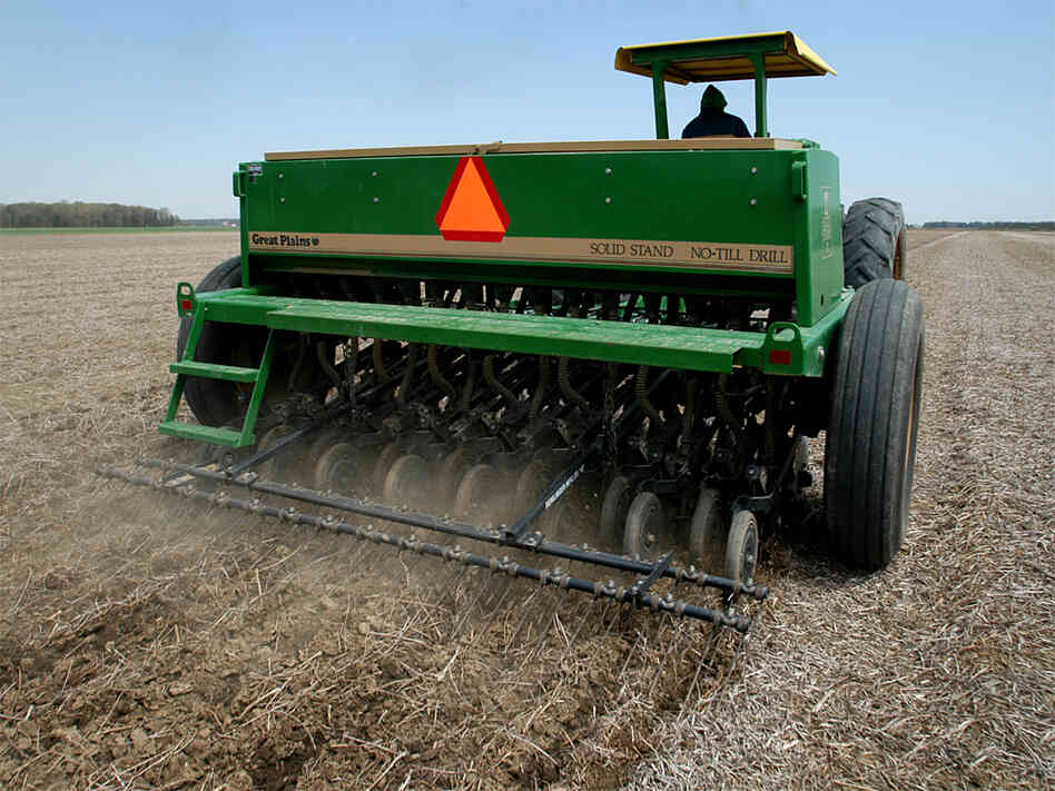 A farmer plants soybeans in an untilled field.