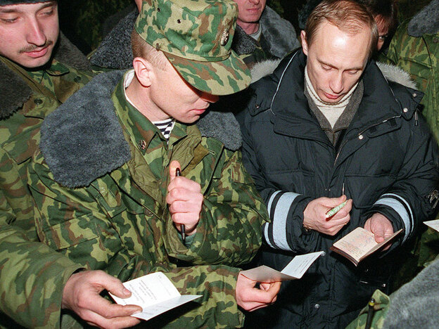 Vladimir Putin signs autographs for Russian soldiers, east of the Chechen capital, Grozny