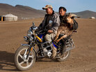 Ninja miners carry a ram by motorcycle through a gold mining camp in Mongolia. Ninja miners carry a ram by motorcycle through a gold mining camp in Mongolia.
