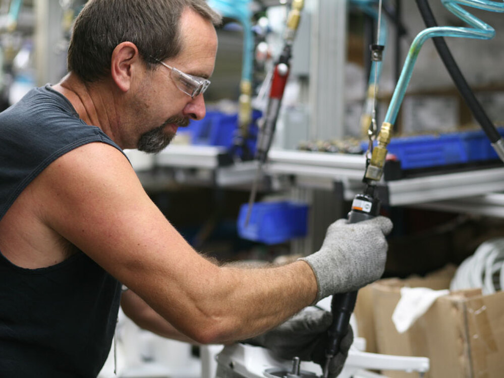 Dwight Bevins assembling part of the pedestal on the KitchenAid Classic.