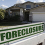 A foreclosure sign sits outside a home for sale in Phoenix, Feb. 17, 2009.
